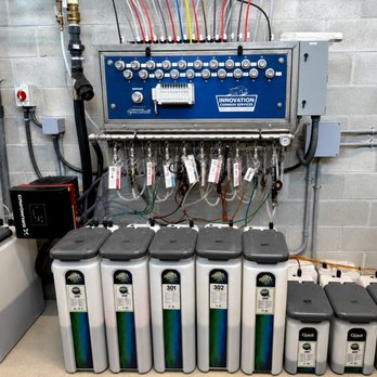 Car wash chemical dosing panel connected to labeled chemical containers